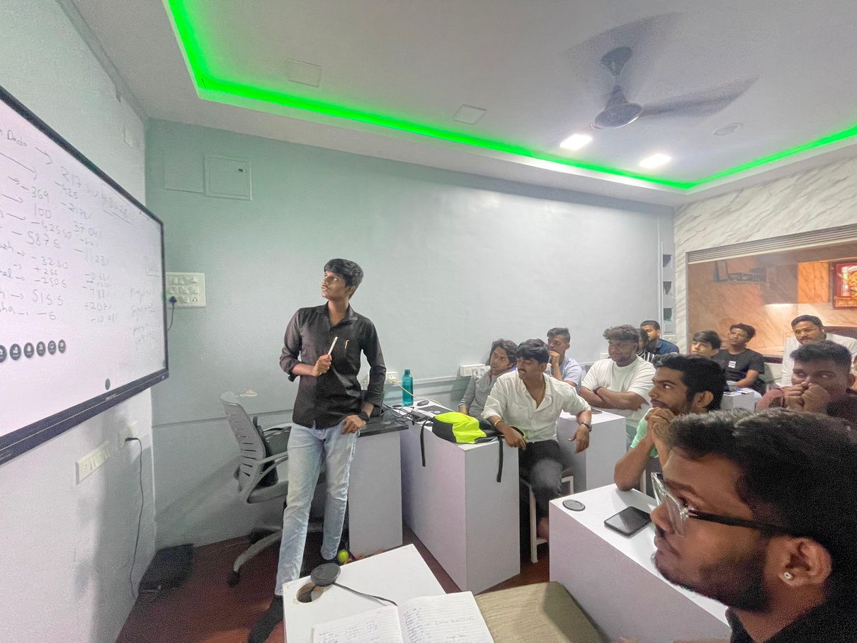 A trainer teaching a full classroom of students at SMT
