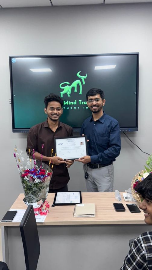Trainer and student with a certificate in the classroom